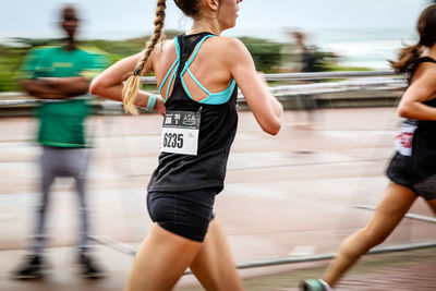 Rear view of woman running