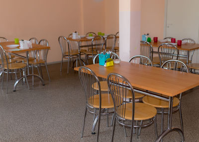 School kitchen canteen, metal table and chair legs, canteen equipment, catering establishment