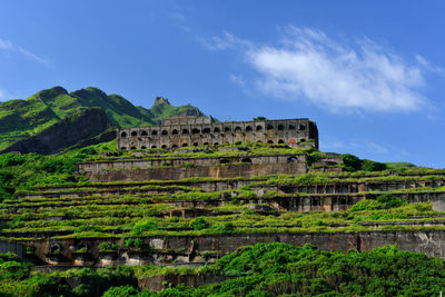 Ruins of building against cloudy sky