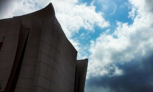 Low angle view of building against cloudy sky