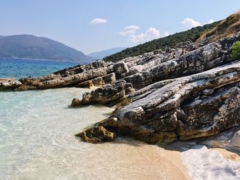 Scenic view of sea and mountains against sky