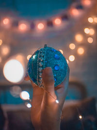 Close-up of hand holding illuminated lighting equipment