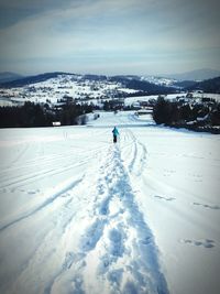 Scenic view of snow covered field against sky