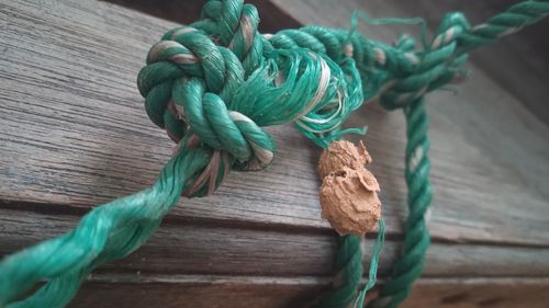 High angle view of rope tied on wood