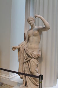 Low angle view of statue against white wall, sculpture, greek, museum. 