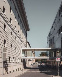 Street amidst buildings against clear sky