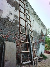 Low angle view of weathered wall against building