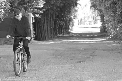 Man riding bicycle on road