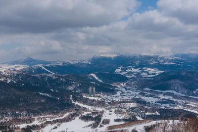 Aerial view of snowcapped mountains against sky