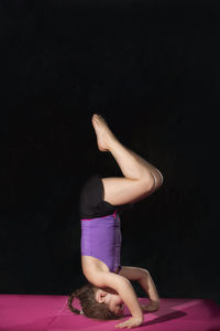 Midsection of woman wearing mask against black background