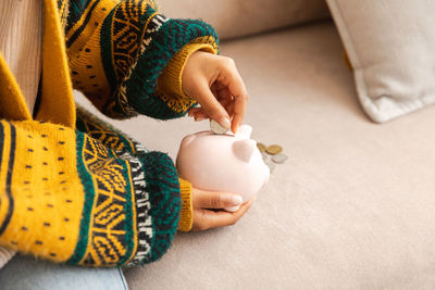 Midsection of woman holding christmas decoration