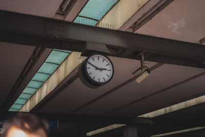 Low angle view of clock on ceiling at railroad station