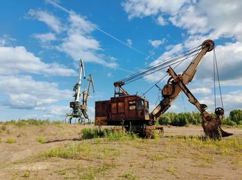 Abandoned truck on field against sky