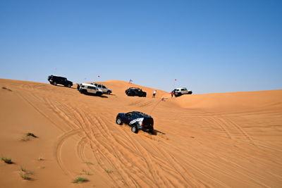 View of motorcycle on desert against clear sky