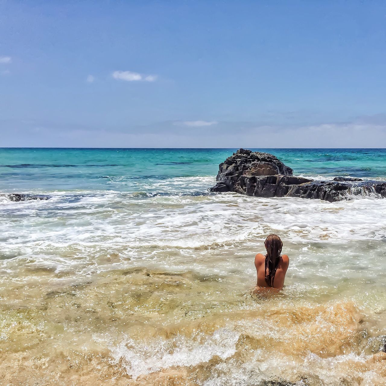 sea, horizon over water, water, beach, sky, shore, scenics, leisure activity, wave, beauty in nature, vacations, lifestyles, tranquil scene, nature, tranquility, rock - object, surf, person