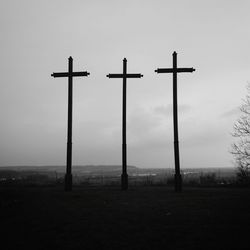 Cross on landscape against sky