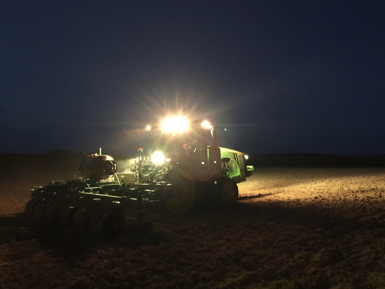 VIEW OF TRACTOR AT SUNSET