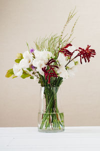 Close-up of white flowers in vase on table