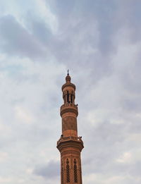 Low angle view of tower of building against cloudy sky