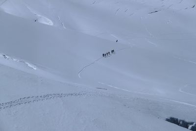 Aerial view of people skiing on snowcapped mountain