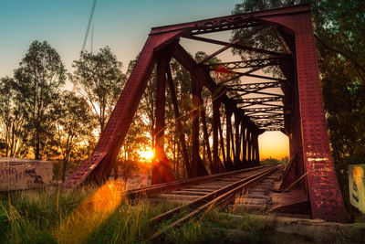 Railroad tracks against sky during sunset