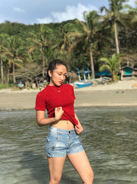 Full length of a girl standing on beach