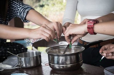 Friends preparing food at campsite