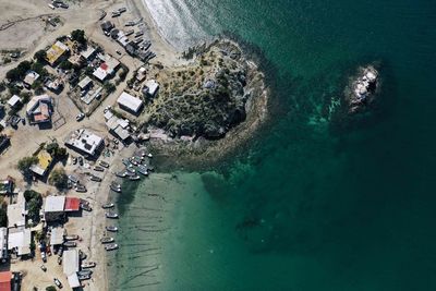 High angle view of sea and buildings in city