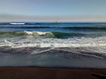 Scenic view of beach against clear sky