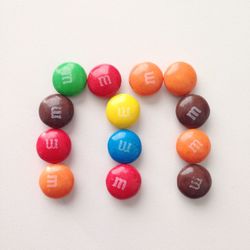 Close-up of multi colored candies against white background