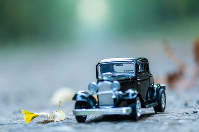 Close-up of toy car on street