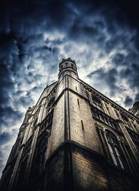 Low angle view of building against cloudy sky