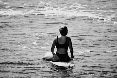 Rear view of woman in sea