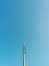 Low angle view of street light against clear blue sky