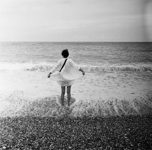 Rear view of man standing on beach