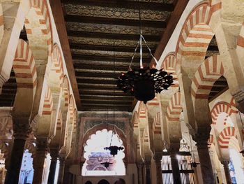 Low angle view of sculptures hanging on ceiling of building