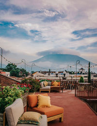 Potted plants on table by sea against sky