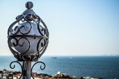 Close-up of metal object against clear sky