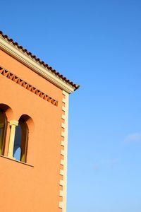 Low angle view of building against clear blue sky