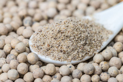 Close-up of white pepper on a white spoon