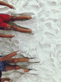 Low section of siblings on sand