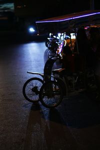 Man cycling on illuminated bicycle at night