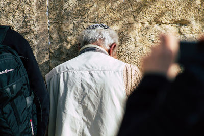 Rear view of man photographing