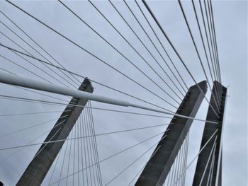 Low angle view of suspension bridge against sky