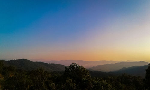 Scenic view of silhouette mountains against clear sky