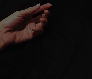 Close-up of hands over black background