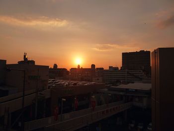 High angle view of buildings against sky during sunset