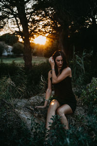 Woman sitting on a tree