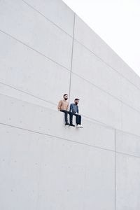 Men standing in front of office building