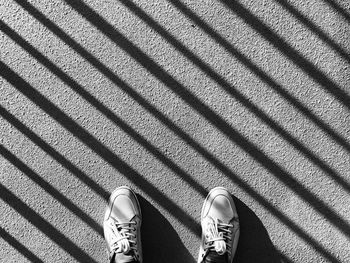 Low section of person standing on road